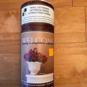 Wall lettering by DCEV. “Welcome family neighbors  friends”.